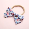 Close-up of khaki nylon baby headband with a floral bow featuring pink roses and blue flowers - Style 1 Pink Floral