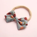 Close-up of floral print cotton bow and soft beige nylon elastic baby headband - Style 2 Red Floral
