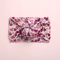 Detail shot of boho floral print baby headband with a soft nylon donut knot design - Small Daisy