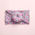 Detailed view of bohemian floral baby headband with a 3D donut knot on soft lilac fabric - Pink Morning Glory