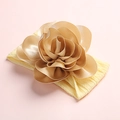 Soft nylon baby headband with a large champagne gold metallic flower decoration - Beige