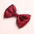 Detailed view of a silky red satin bow hair clip for girls on a soft pink background - Wine Red (5)
