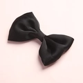 Close-up of the black satin bow hair clip showing smooth texture and elegant silk luster - Black