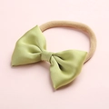 Close-up of a light green satin bow headband for babies with beige elastic nylon band - Light Green (13)