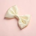 Detailed macro view of the cream satin silk texture on a girls double-wing bow hair clip - Cream White (21)