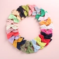 Flat lay of colorful bow headbands for babies in a circular arrangement on pink background - Random Mixed Colors