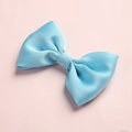 Close-up of light blue satin hair bow with silky texture on soft pink background - 15