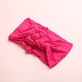 Dettaglio della fascia per neonata in nylon fucsia a pois bianchi con nodo centrale - Rosa Fuchsia
