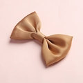 Detailed close-up of a premium golden satin bow hair clip with smooth silk texture - 22