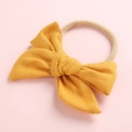Detail of soft ginger yellow cotton bow headband with seamless elastic nylon band - Ginger Yellow