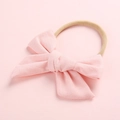 Detailed view of pink cotton bow headband with high elasticity nude nylon band - Dusty Pink