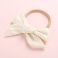 Detail of soft cream white cotton bow headband with high-elastic nylon band for infants - Off White