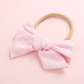 Detailed texture of pink cotton bow headband with elastic khaki nylon band for babies - Light Pink