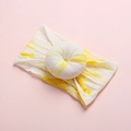 Detailed close-up of yellow and white tie-dye nylon headband with donut-shaped bow - Yellow White Tie-dye Style (8)