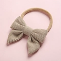 Detailed texture of beige corduroy bow on a soft nylon baby headband accessory - Light Camel (9)
