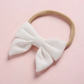 Detailed view of white corduroy bow hairband with soft nylon elastic band for infants - White (13)