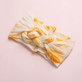 Close-up of baby tie-dye headband with soft orange and white fabric and center knot detail - Orange White Tie-Dye (10)