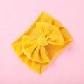 Detail of a bright yellow velvet bow headband for babies with soft ribbed fabric texture - Bright yellow