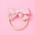 Dettaglio fiocco in mussola rosa chiaro su fascia elastica in nylon per neonati - Rosa Cipria