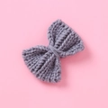 Detailed view of gray knitted bow hair clip featuring a soft ribbed texture and handwoven finish - Gray