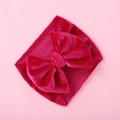 Detail of soft velvet baby headband with large bow knot in vibrant rose red - Rose Red