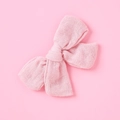 Detail of soft muslin bow hair clip in pink featuring breathable double layer gauze texture - Dusty Pink
