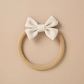 Close-up of baby bow headband showing beige wave pattern and soft nylon band - White Wave Texture Bow (5)