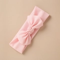 Close-up of a soft pink knit headband for babies with a delicate tied bow detail - Pink Style (7)