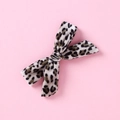 Macro detail of the soft leopard print velvet texture on this handmade girls bow hair clip - Elegant Creamy Leopard