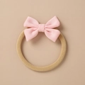 Detailed close-up of pink knitted bow with elastic nylon headband for baby hair - Pink Knit Bow (7)