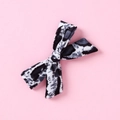 Close-up of leopard print velvet bow hair clip for girls on a soft pink background - Black White Grey Leopard