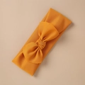 Detail of ginger yellow elastic knitted baby headband with a large decorative bow tie - Ginger Yellow Style (11)