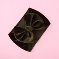 Detail of olive green velvet baby headband with a large bow on pink background - Olive Green