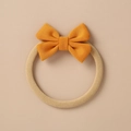 Macro view of ginger knitted bow headband with elastic beige band for infants - Ginger Yellow Fine Knit Bow (12)
