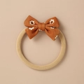 Detail of soft knitted baby headband with a brown daisy bow in vintage floral style - Light Camel Daisy Print Bow (15)