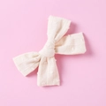Detailed close-up of cream white cotton bow hair clip with textured polka dot fabric - Light Yellow
