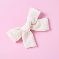 Detail of a handmade cream white cotton bow hair clip with fine grid texture for girls - Cream
