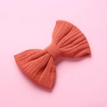 Trama dettagliata del fiocco per capelli in mussola di cotone rosso su sfondo rosa - Arancione Zucca