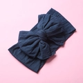 Detail of soft navy blue nylon wide headband featuring a large layered bow for babies - Ink Blue