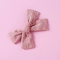 Close-up of pink cotton jacquard bow clip with textured stripes and 3D swiss dots - Brown