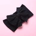 Close-up of soft black nylon baby headband featuring a large double-layered bow detail - Black