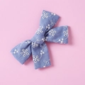 Close-up of blue cotton lace hair bow with white floral embroidery for girls - Light Blue