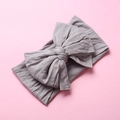 Detailed texture of gray nylon bow headband with soft stretch fabric for infants - Gray