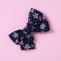 Detailed macro view of navy cotton lace bow with delicate white floral embroidery - Dark Blue