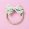 Detail of mint green jacquard bow headband with high-elastic soft nylon band for babies - Light Green