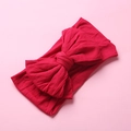 Detail of red elastic nylon infant headband featuring a soft double-layered bow knot - Dark Red