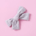 Detailed close-up of lilac cotton jacquard bow hair clip with Swiss dot texture - Gray