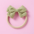 Detail of baby headband with green jacquard bow and soft elastic nylon fabric band - Green