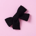 Detail showing the waffle textured fabric and symmetrical bow design of this black hair clip - 10 Black