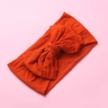 Detail of burnt orange nylon headband with large soft knotted bow for babies - Orange Red